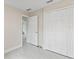 Bedroom featuring neutral walls, tile floors, a large window and double closets at 1135 Holly Ave, Daytona Beach, FL 32117