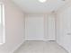 Bedroom featuring neutral walls, tile floors, a large window, and double closets at 1135 Holly Ave, Daytona Beach, FL 32117