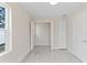 Bedroom features neutral walls, tile floors, a large window, and double closets at 1135 Holly Ave, Daytona Beach, FL 32117