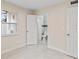 Bedroom with neutral walls, tile floors, white door, and a bathroom at 1135 Holly Ave, Daytona Beach, FL 32117