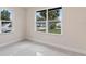 Bedroom featuring neutral walls, tile floors, and a large window with a neighborhood view at 1135 Holly Ave, Daytona Beach, FL 32117