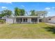 Charming single-story home featuring a well-maintained lawn and contrasting black shutters at 1135 Holly Ave, Daytona Beach, FL 32117