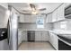 Modern kitchen features white cabinets, stainless steel appliances, and stylish countertops, creating a sleek and functional space at 1135 Holly Ave, Daytona Beach, FL 32117