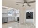 Modern kitchen features white cabinets, stainless steel appliances, and stylish countertops, plus a fireplace in the back at 1135 Holly Ave, Daytona Beach, FL 32117