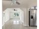 Bright living room with pristine white walls and tile floors offering a seamless transition to the kitchen area at 1135 Holly Ave, Daytona Beach, FL 32117
