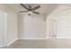 Neutral living room with tile floors, ceiling fan, and an open doorway leading to adjacent rooms at 1135 Holly Ave, Daytona Beach, FL 32117