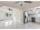 Bright living room with pristine white walls and tile floors offering a seamless transition to the kitchen area at 1135 Holly Ave, Daytona Beach, FL 32117
