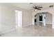 Neutral living room with tile floors, ceiling fan, and an open doorway leading to adjacent rooms at 1135 Holly Ave, Daytona Beach, FL 32117
