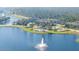 Aerial view displays a community pool and lake with a fountain at 118 Grande Belfly Way, Daytona Beach, FL 32124