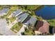An aerial view showcases homes bordering a tranquil pond and lush trees at 118 Grande Belfly Way, Daytona Beach, FL 32124
