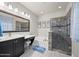 Well-lit bathroom with dark cabinets, double vanity, bath, walk-in shower, and tiled floor at 118 Grande Belfly Way, Daytona Beach, FL 32124
