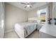 Bright bedroom with a full-sized bed, white furnishings, and light-filled window at 118 Grande Belfly Way, Daytona Beach, FL 32124