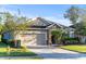 Attractive single-story home featuring a two-car garage and lush landscaping at 118 Grande Belfly Way, Daytona Beach, FL 32124