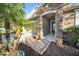 Close-up of a stone-clad front entrance with potted plants at 118 Grande Belfly Way, Daytona Beach, FL 32124