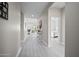Bright hallway with light gray plank flooring, neutral walls, and views of the living room and bedroom at 118 Grande Belfly Way, Daytona Beach, FL 32124