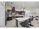 Modern kitchen with dark cabinets, a center island with seating, and stainless steel appliances at 118 Grande Belfly Way, Daytona Beach, FL 32124