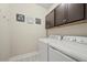 Functional laundry room featuring modern appliances and ample storage cabinets at 118 Grande Belfly Way, Daytona Beach, FL 32124