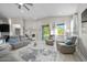 Inviting living room featuring comfortable seating, neutral decor, and sliding glass doors to the outdoors at 118 Grande Belfly Way, Daytona Beach, FL 32124