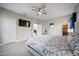 Well-lit main bedroom features a ceiling fan, tv, and ensuite bathroom with stand-up shower at 118 Grande Belfly Way, Daytona Beach, FL 32124
