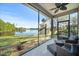 Serene sunroom with scenic lake views and comfortable seating area at 118 Grande Belfly Way, Daytona Beach, FL 32124