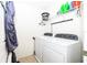 Laundry room with washer, dryer and shelving at 1183 Honey Blossom Dr, Orlando, FL 32824