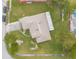 Aerial view of the home featuring a well-maintained roof, spacious yard, and inviting driveway at 134 Deskin Dr, South Daytona, FL 32119