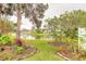 Lush backyard with a tranquil pond view surrounded by mature trees and landscaping at 134 Deskin Dr, South Daytona, FL 32119