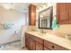 Bathroom features wood cabinets, a large mirror, and well-maintained tile flooring at 134 Deskin Dr, South Daytona, FL 32119