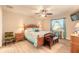 Comfortable bedroom boasts a ceiling fan, television, and light wood-look vinyl plank flooring at 134 Deskin Dr, South Daytona, FL 32119