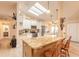 Open-concept kitchen with a large island, skylights, and wood-look floors at 134 Deskin Dr, South Daytona, FL 32119