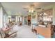 Bright sunroom features ceiling fans and ceramic tile flooring throughout at 134 Deskin Dr, South Daytona, FL 32119