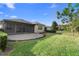 A paver patio complements the beautiful lush backyard and landscaping at 1341 Hayton Ave, Deland, FL 32724