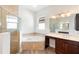 Bathroom featuring a soaking tub, a glass enclosed shower, and double vanity sinks at 1341 Hayton Ave, Deland, FL 32724