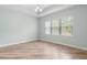 Bright bedroom with wood flooring, tray ceiling, and a large window with natural light at 1341 Hayton Ave, Deland, FL 32724