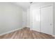Bedroom with wood-look floors and a double door closet at 1341 Hayton Ave, Deland, FL 32724