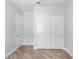 Simple bedroom with wood flooring, white walls, and a closet at 1341 Hayton Ave, Deland, FL 32724