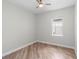 Bedroom with wood-look floors, ceiling fan, and window at 1341 Hayton Ave, Deland, FL 32724
