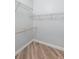 Walk-in closet featuring wire shelving and a wooden hanging rod at 1341 Hayton Ave, Deland, FL 32724