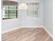 Bright dining area featuring hardwood floors and a light wicker pendant light at 1341 Hayton Ave, Deland, FL 32724