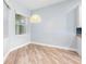 Dining area offering bright light and hardwood flooring with an interesting wicker light fixture at 1341 Hayton Ave, Deland, FL 32724
