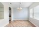 Bright dining room featuring wood floors, a chandelier, and built-in shelving for elegant dining at 1341 Hayton Ave, Deland, FL 32724