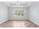 Bright dining room featuring wood floors, tray ceiling, recessed lights, and large windows at 1341 Hayton Ave, Deland, FL 32724