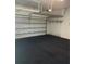 Spacious garage with ample overhead storage racks and shelving units at 1341 Hayton Ave, Deland, FL 32724