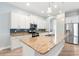 Bright open kitchen featuring granite countertops, stainless appliances, and a large center island at 1341 Hayton Ave, Deland, FL 32724