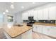 Well-lit kitchen features a large island with sink, granite counters, and stainless steel appliances at 1341 Hayton Ave, Deland, FL 32724