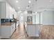 Open kitchen boasts granite countertops, stainless steel appliances and island with sink at 1341 Hayton Ave, Deland, FL 32724