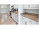 Kitchen counter with granite countertops, white cabinets, and stainless steel appliances at 1341 Hayton Ave, Deland, FL 32724