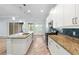 Spacious kitchen with granite counters, stainless steel appliances and light wood flooring at 1341 Hayton Ave, Deland, FL 32724