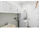 Laundry area features stacked washer/dryer and storage cabinets at 1341 Hayton Ave, Deland, FL 32724
