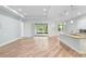 Open-concept living area boasts wood floors, recessed lighting, sliding glass doors, and a kitchen island at 1341 Hayton Ave, Deland, FL 32724